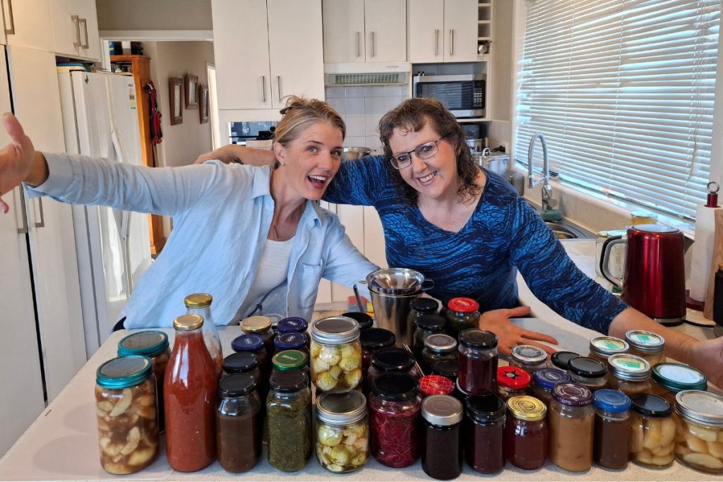 Elle and Katherine showing off preserves they make in their beginners online preserving course